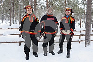 Three Sami men in snow in Lapland, Finland